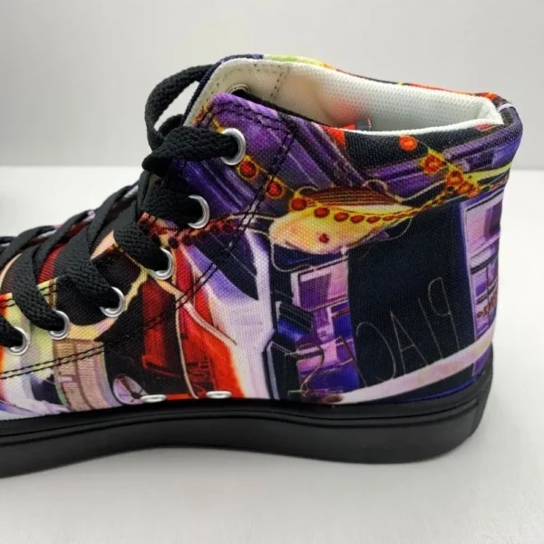 Paul Corps custom printed high-top canvas shoe featuring a vibrant, abstract cityscape design in bold colors with black laces and sole. Showing inside back of shoe.