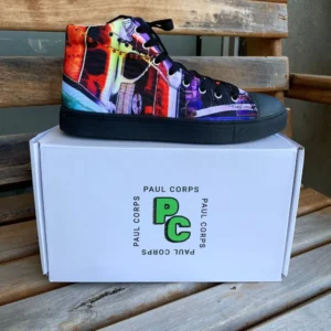 Paul Corps custom printed high-top canvas shoe featuring a vibrant, abstract cityscape design in bold colors with black laces and sole. With Shoe on top of Branded Paul Corps Shoe Box