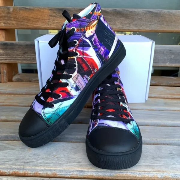 Paul Corps custom printed high-top canvas shoe featuring a vibrant, abstract cityscape design in bold colors with black laces and sole. With shoes in front of Branded Paul Corps Show Box with one shoe on top of the other.