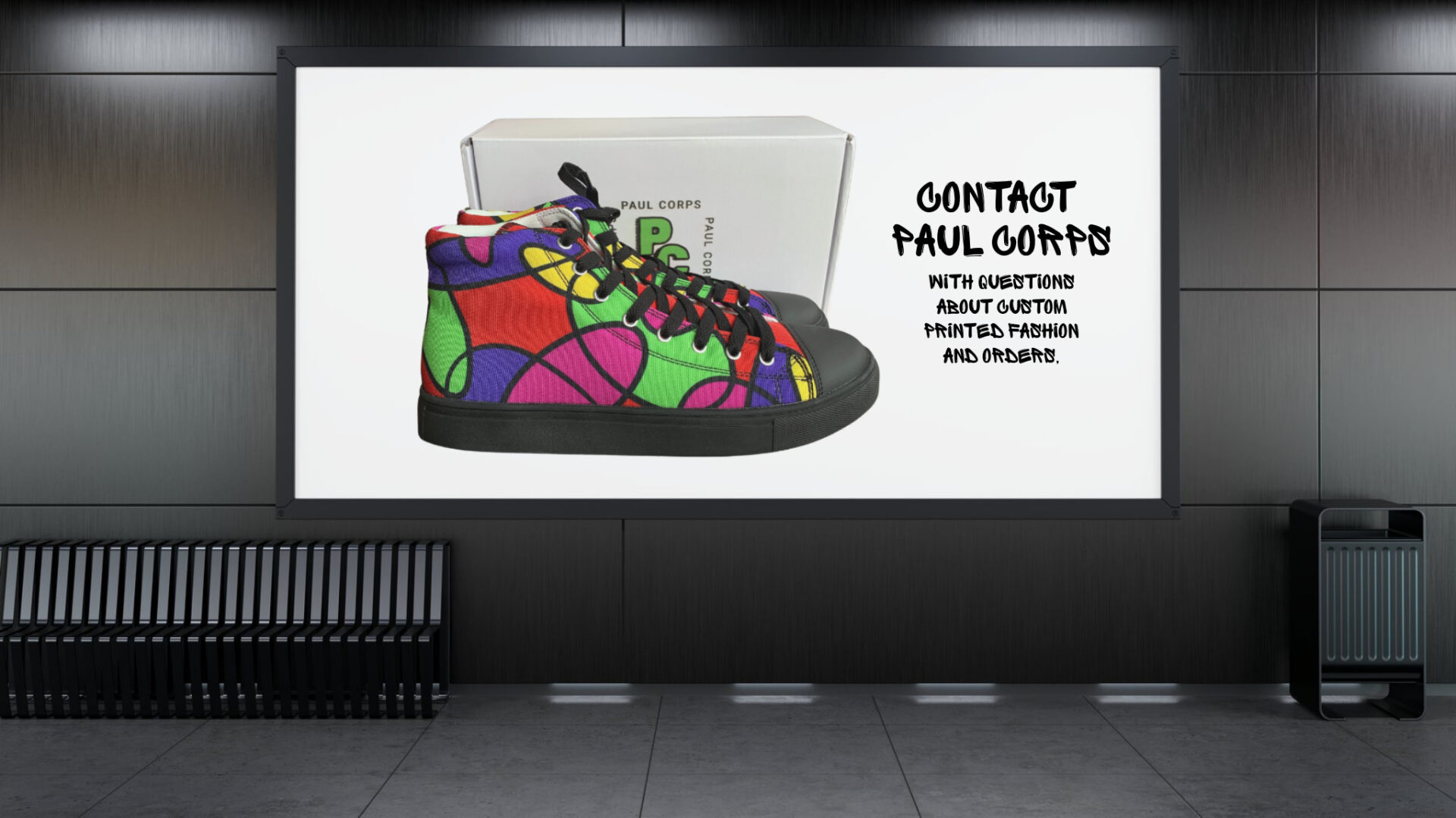A billboard in a modern indoor space displays a pair of colorful Paul Corps high-top canvas shoes with a bold abstract pattern in red, green, purple, and yellow, black soles and laces, positioned in front of a branded white Paul Corps shoebox. Beside the shoes, black graffiti-style text reads: "Contact Paul Corps with questions about custom printed fashion and orders."