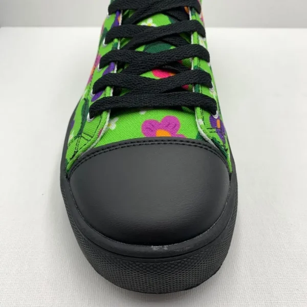 A pair of vibrant Paul Corps green high-top canvas shoes with a colorful floral pattern, black laces, and black soles, showing front toe.