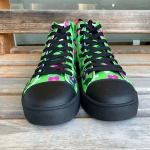 A pair of vibrant Paul Corps green high-top canvas shoes with a colorful floral pattern, black laces, and black soles, facing front