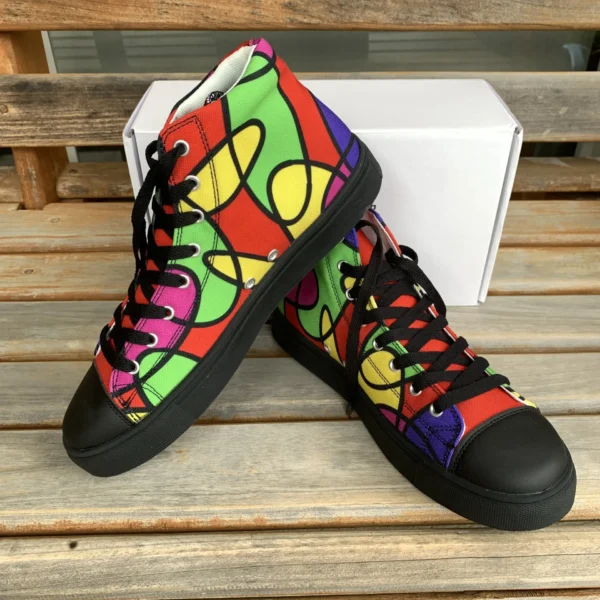 Angled side view of Paul Corps Lava Lamp Memories high-top canvas shoes, one shoe standing and the other leaning against it, highlighting the vivid, abstract pattern and black soles, with a white Paul Corps box in the background.