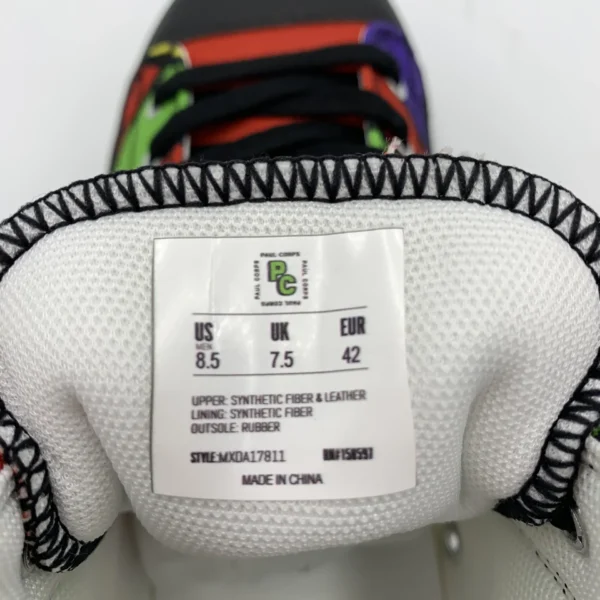 Detailed shot of the tongue label inside a Lava Lamp Memories high-top canvas shoe by Paul Corps, displaying size information, materials, and the PC logo above the laces.