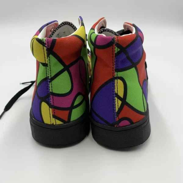 Rear view of a pair of Lava Lamp Memories high-top canvas shoes by Paul Corps, showing the colorful abstract pattern in green, red, yellow, and purple with black soles.