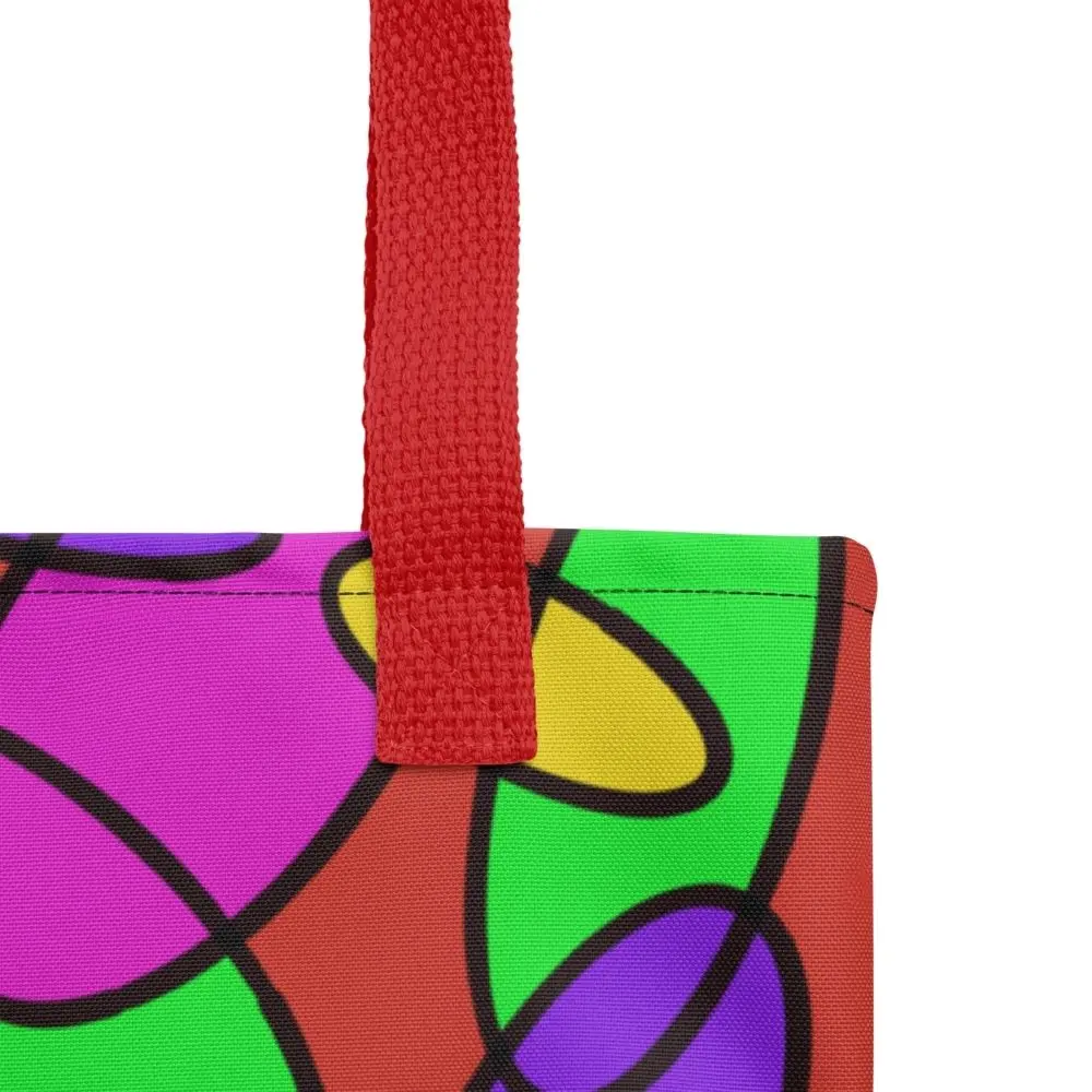 Close-up of the top corner of a Lava Lamp Memories all-over print tote bag, showing the red handle and detailed stitching with the colourful abstract pattern in green, purple, yellow, and pink