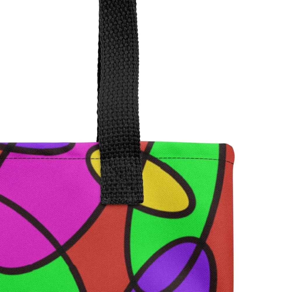 Close-up of the top corner of a Lava Lamp Memories all-over print tote bag, showing the black handle and detailed stitching with the colourful abstract pattern in green, purple, yellow, and pink