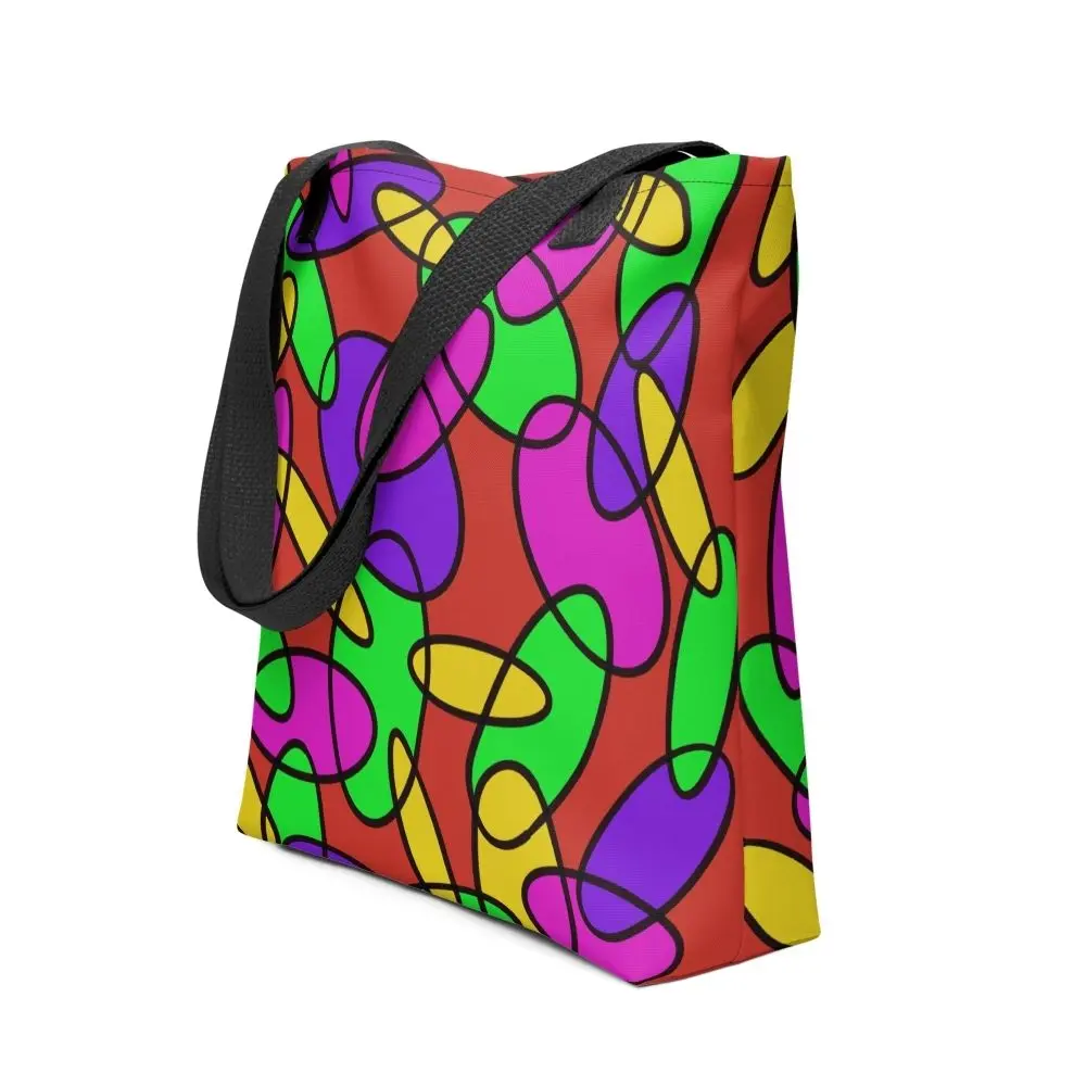 A Lava Lamp Memories all-over print tote bag with a vibrant abstract pattern in green, purple, yellow, and pink on a red background, featuring black handles