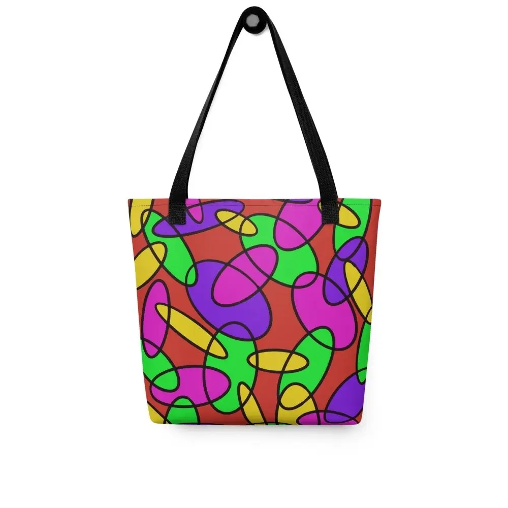 Front view of a Lava Lamp Memories all-over print tote bag with red handles, featuring a bold abstract pattern in green, purple, yellow, and pink on a red background