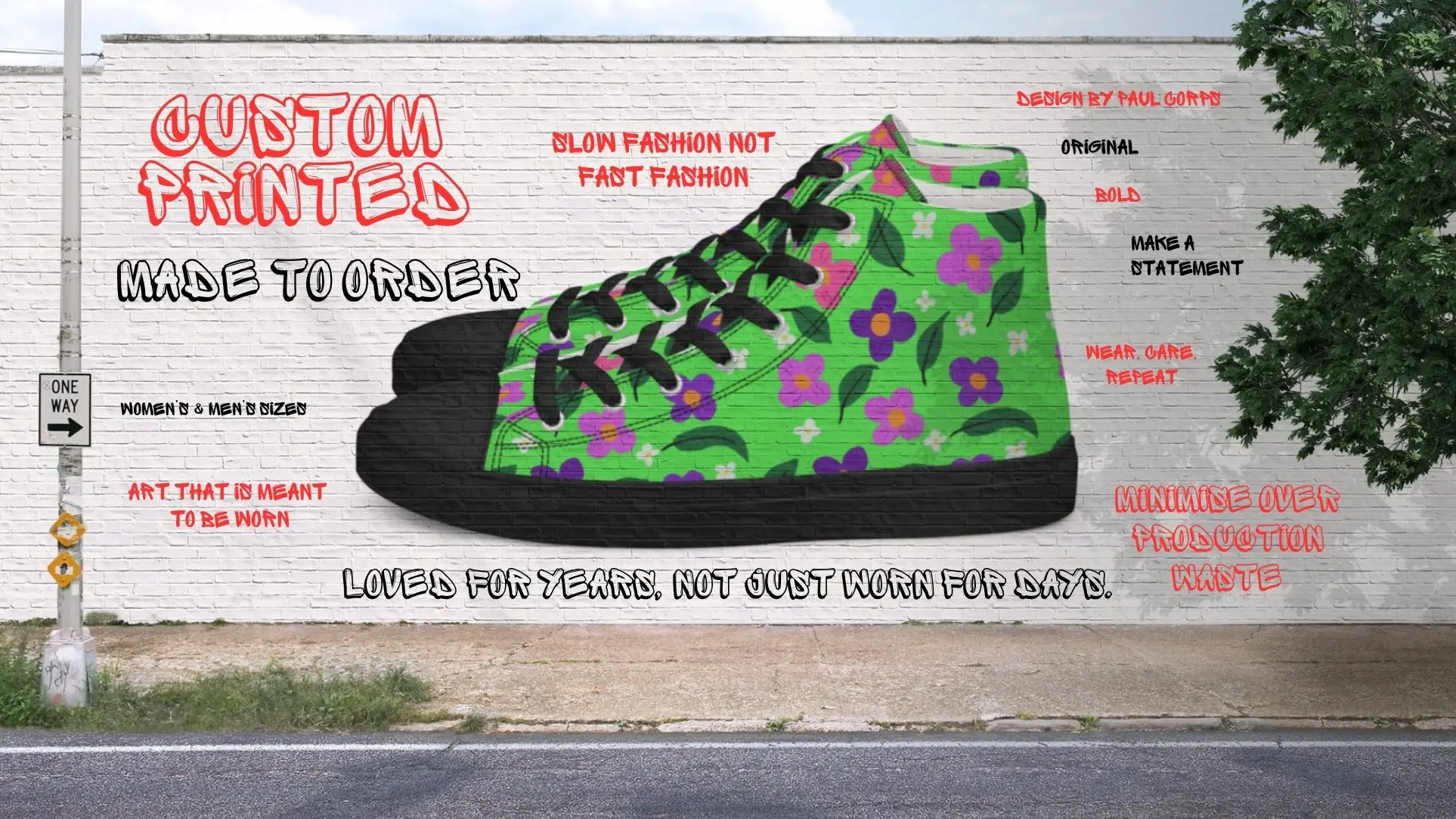 A mural on a white brick wall featuring a large green custom high-top canvas shoe with a purple and yellow floral pattern, black laces, and black sole, surrounded by graffiti-style text promoting custom printed, made-to-order shoes and sustainable wearable art by Paul Corps.