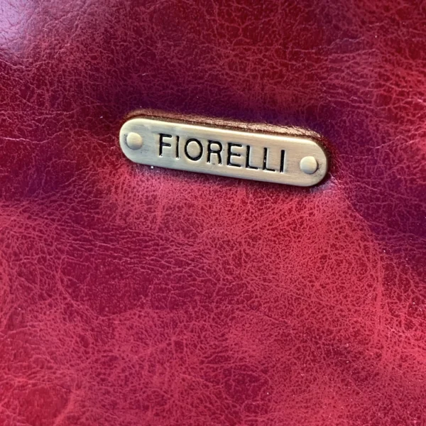 Vintage Fiorelli red shoulder bag with faux croc and snakeskin texture, gold-tone hardware, and zip closure, displayed on a blue satin background.