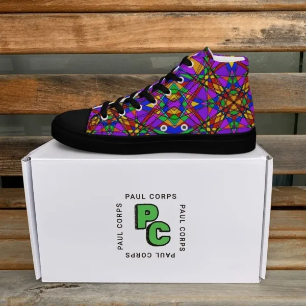 A pair of Paul Corps high-top canvas shoes featuring a bold, multicolored stained glass effect pattern with intersecting lines in purple, orange, green, blue, and red, set against black soles and laces. The shoes are displayed in front of a white Paul Corps branded box on a wooden surface.