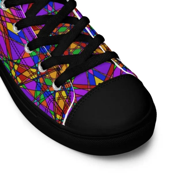 A pair of Paul Corps high-top canvas shoes featuring a bold, multicolored stained glass effect pattern with intersecting lines in purple, orange, green, blue, and red, set against black soles and laces. This is showing the toe of the shoe.