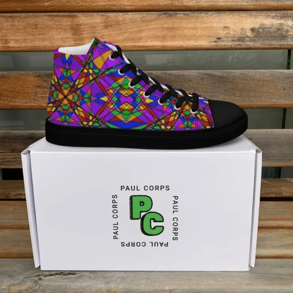 A pair of Paul Corps high-top canvas shoes featuring a bold, multicolored stained glass effect pattern with intersecting lines in purple, orange, green, blue, and red, set against black soles and laces. The shoes are displayed in front of a white Paul Corps branded box on a wooden surface.
