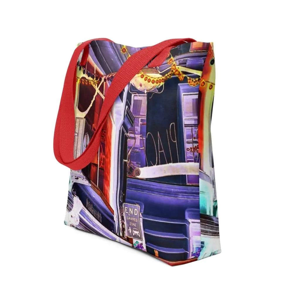 A Paul Corps tote bag featuring a vibrant, digitally enhanced photograph of a Melbourne laneway. The design includes colorful string lights, urban signage, and architectural details in shades of purple, orange, and blue, with black handles.