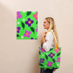 A person wearing a Green Spring all-over print tote bag with yellow handles over their shoulder, standing in front of a matching an art print on a beige wall