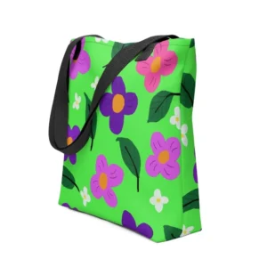 A green Spring all-over print tote bag with a vibrant flower and leaf design in pink, yellow, white and purple, set against a green background, featuring black handles