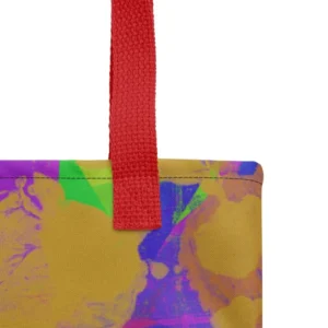 Close-up of the top corner of a Kaleidoscope Dream all-over print tote bag, showing the red handle and detailed stitching with the colourful abstract pattern in green, purple, yellow, blue and pink