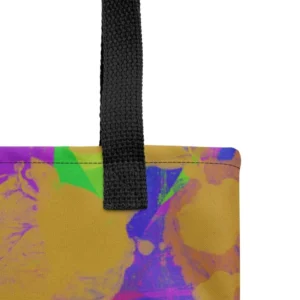 Close-up of the top corner of a Kaleidoscope Dream all-over print tote bag, showing the black handle and detailed stitching with the colourful abstract pattern in green, purple, yellow, blue and pink