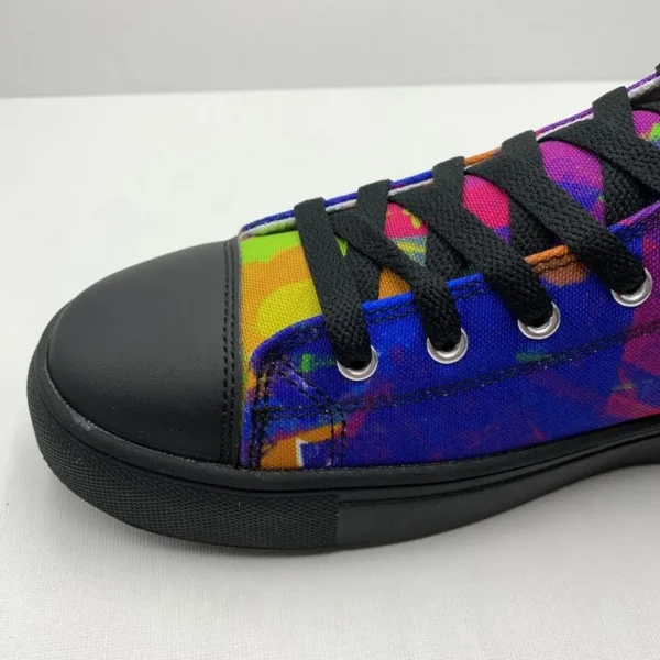 A pair of Paul Corps Kaleidoscope Dream High Top Canvas Shoes featuring a vibrant, abstract pattern in purple, blue, green, and orange, with black laces and black soles, displaying side view of front of shoe