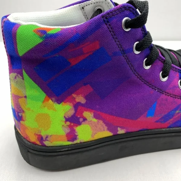A pair of Paul Corps Kaleidoscope Dream High Top Canvas Shoes featuring a vibrant, abstract pattern in purple, blue, green, and orange, with black laces and black soles, displaying back of shoe