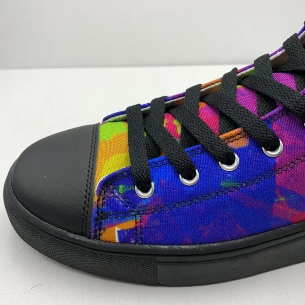 A pair of Paul Corps Kaleidoscope Dream High Top Canvas Shoes featuring a vibrant, abstract pattern in purple, blue, green, and orange, with black laces and black soles, displaying side view of front of shoe