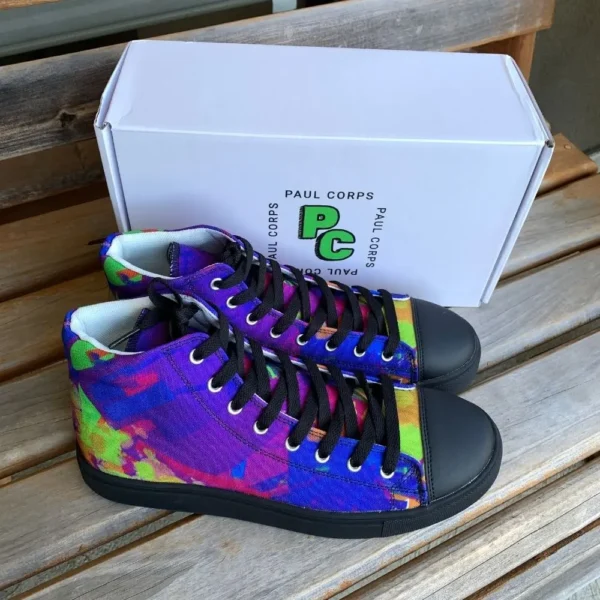 A pair of Paul Corps Kaleidoscope Dream High Top Canvas Shoes featuring a vibrant, abstract pattern in purple, blue, green, and orange, with black laces and black soles, displayed in front of a branded Paul Corps shoe box.