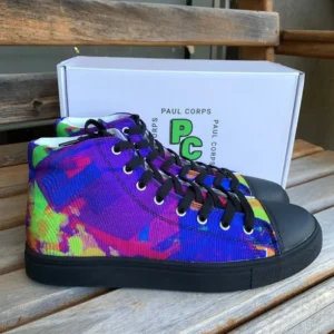 A pair of Paul Corps Kaleidoscope Dream High Top Canvas Shoes featuring a vibrant, abstract pattern in purple, blue, green, and orange, with black laces and black soles, displayed in front of a branded Paul Corps shoe box.