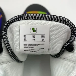 A pair of Paul Corps Kaleidoscope Dream High Top Canvas Shoes featuring a vibrant, abstract pattern in purple, blue, green, and orange, with black laces and black soles, displaying inside Branded Paul Corps Size Label