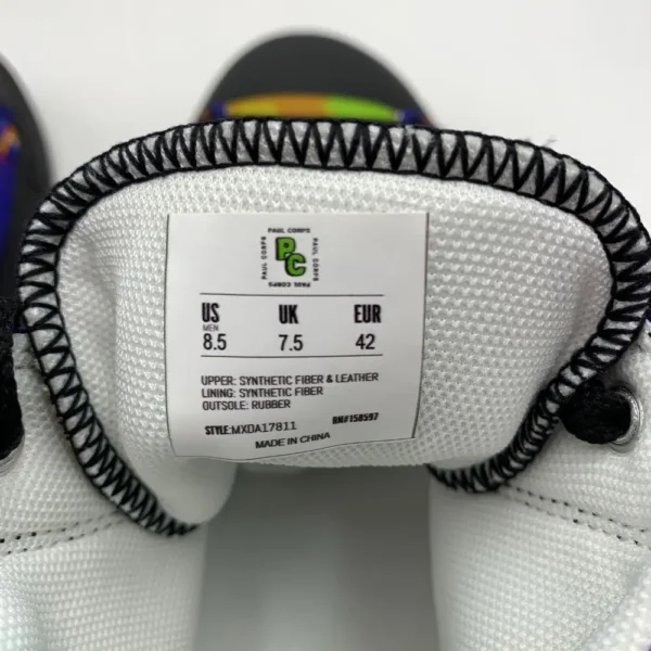 A pair of Paul Corps Kaleidoscope Dream High Top Canvas Shoes featuring a vibrant, abstract pattern in purple, blue, green, and orange, with black laces and black soles, displaying inside Branded Paul Corps Size Label