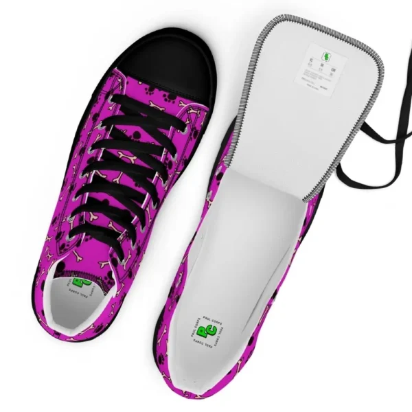 A pair of Paul Corps high-top canvas shoes with a vibrant pink background, decorated with black paw prints and white bone motifs, black laces, and black soles.