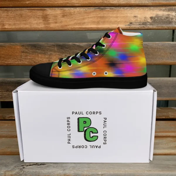 A pair of Paul Corps high-top canvas shoes featuring a bold spray paint-inspired design with vibrant streaks of blue, pink, orange, and yellow, black laces, and black soles, displayed in front of a white Paul Corps branded box.