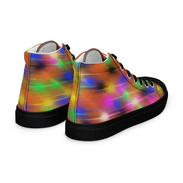 A pair of Paul Corps high-top canvas shoes featuring a bold spray paint-inspired design with vibrant streaks of blue, pink, orange, and yellow, black laces, and black soles.