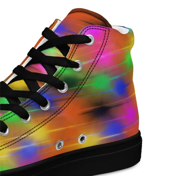 A pair of Paul Corps high-top canvas shoes featuring a bold spray paint-inspired design with vibrant streaks of blue, pink, orange, and yellow, black laces, and black soles.