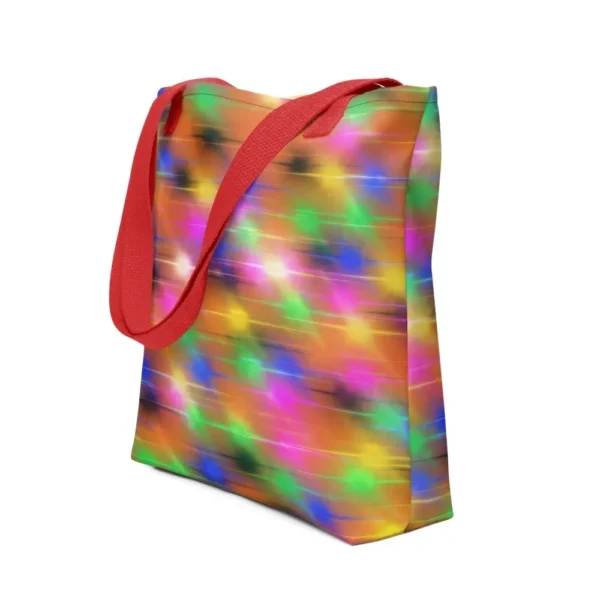 A Paul Corps large tote bag featuring a vibrant spray paint-inspired design with dynamic streaks of blue, pink, orange, and yellow on a black background, finished with sturdy black, red or yellow handles.