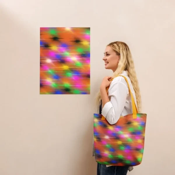 A Paul Corps large tote bag featuring a vibrant spray paint-inspired design with dynamic streaks of blue, pink, orange, and yellow on a black background, finished with sturdy black, red or yellow handles.