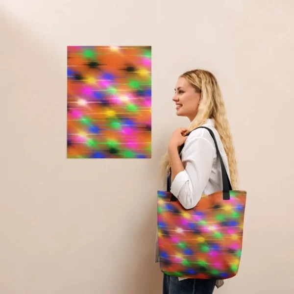 A Paul Corps large tote bag featuring a vibrant spray paint-inspired design with dynamic streaks of blue, pink, orange, and yellow on a black background, finished with sturdy black, red or yellow handles.