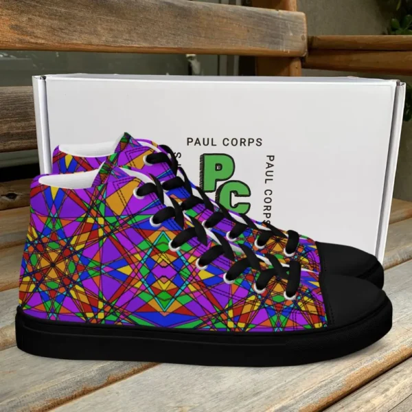 A pair of Paul Corps high-top canvas shoes featuring a bold, multicolored stained glass effect pattern with intersecting lines in purple, orange, green, blue, and red, set against black soles and laces. The shoes are displayed in front of a white Paul Corps branded box on a wooden surface.