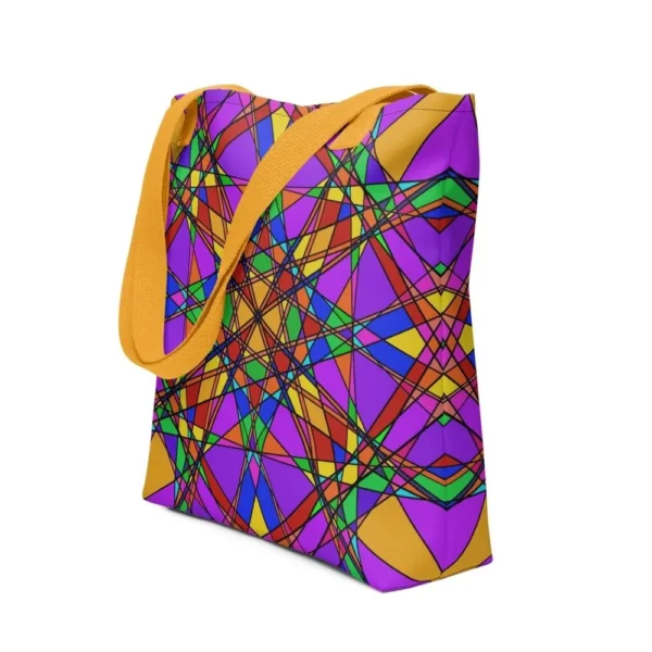 A Stain Glass Effect all-over print tote bag with a vibrant abstract pattern in green, purple, yellow, and pink, featuring yellow handles