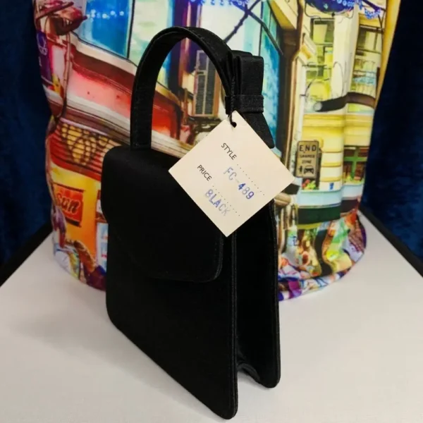 A pre-loved Olga Berg Classic Mini Top Handle Bag in sleek black with a structured silhouette and a chic top handle