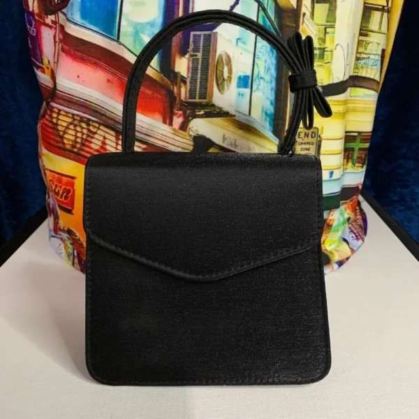 A pre-loved Olga Berg Classic Mini Top Handle Bag in sleek black with a structured silhouette and a chic top handle
