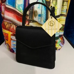 A pre-loved Olga Berg Classic Mini Top Handle Bag in sleek black with a structured silhouette and a chic top handle