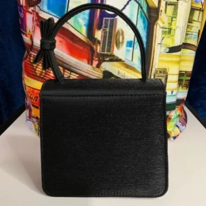 A pre-loved Olga Berg Classic Mini Top Handle Bag in sleek black with a structured silhouette and a chic top handle
