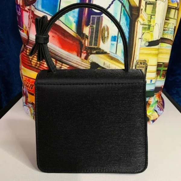 A pre-loved Olga Berg Classic Mini Top Handle Bag in sleek black with a structured silhouette and a chic top handle