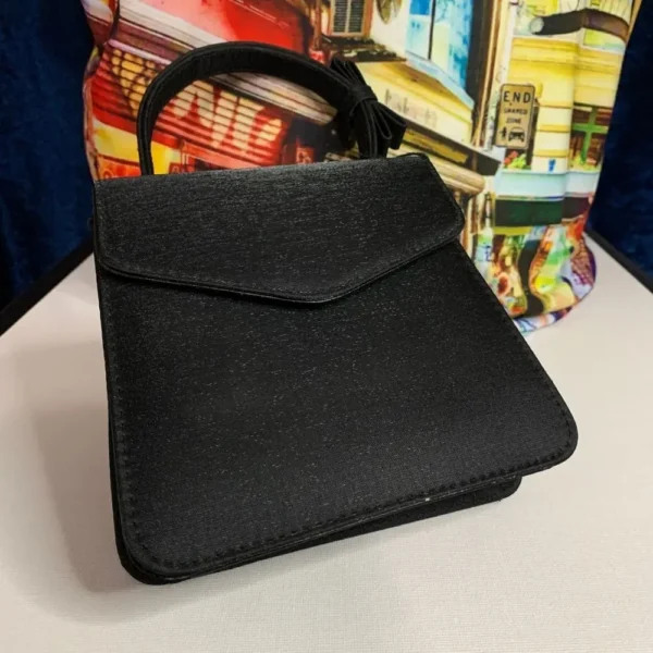 A pre-loved Olga Berg Classic Mini Top Handle Bag in sleek black with a structured silhouette and a chic top handle