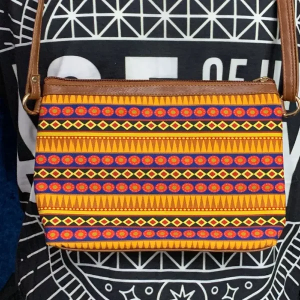 Rear of All Things Sundar sling bag featuring neutral beige fabric and stitched detailing.